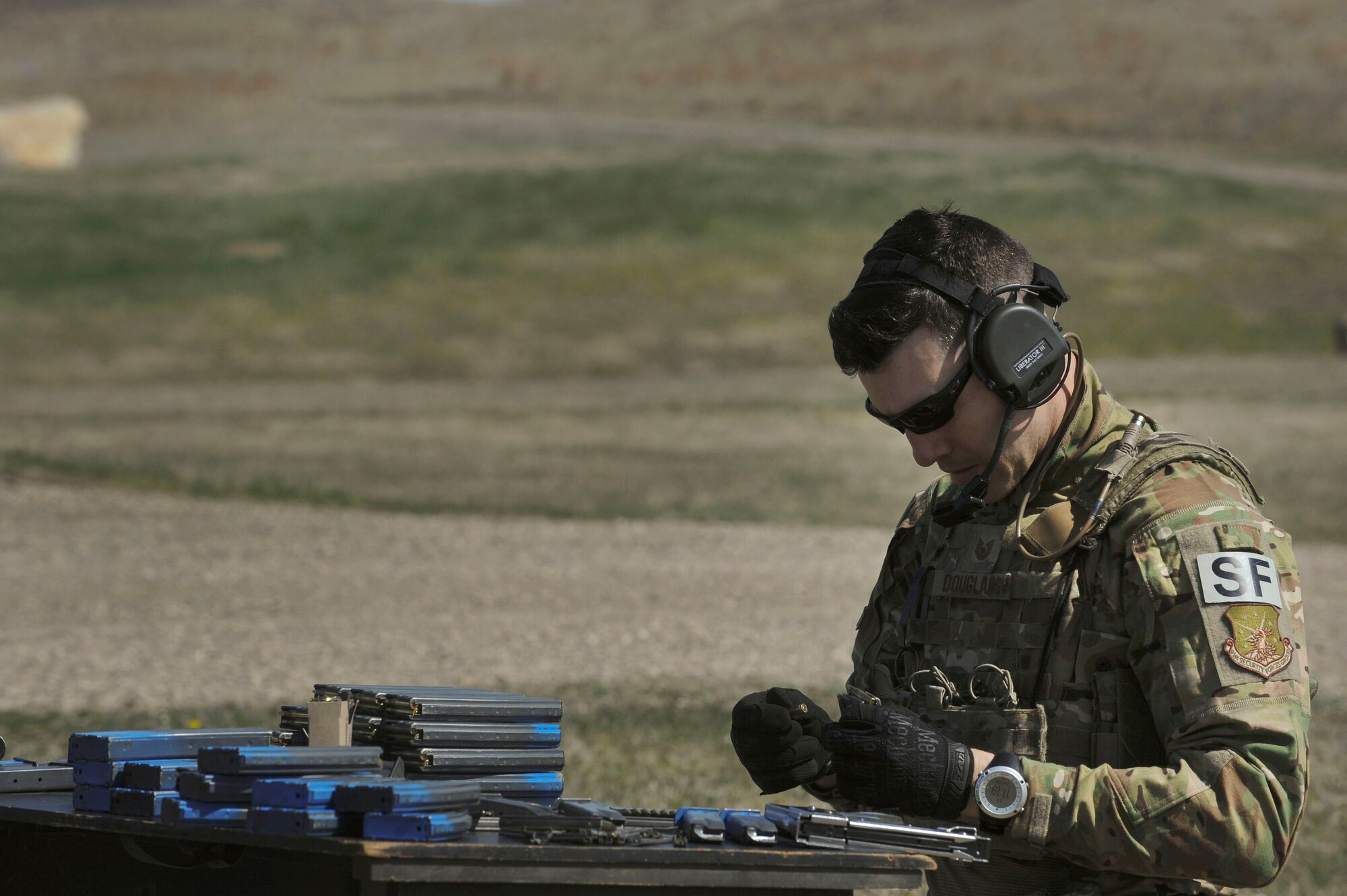 Staff Sgt. Kyle Douglass, 91st Security Forces Group physical security NCO in charge, loads a magazine at Camp Grafton South, Devil’s Lake, N.D., May 4, 2017. The 91st SFG Global Strike Challenge team trained in preparation for the upcoming competition, which challenges security forces tactics, job knowledge and weapons firing. (U.S. Air Force photo/Airman 1st Class Jessica Weissman)