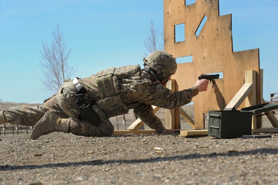 Airman Ryan Benjamin, 91st Missile Security Forces Squadron response force member, fires an M9 pistol at Camp Grafton South, Devil’s Lake, N.D., May 4, 2017. The 91st Security Forces Group Global Strike Challenge team trained in preparation for the upcoming competition, which challenges security forces tactics, job knowledge and weapons firing. (U.S. Air Force photo/Airman 1st Class Jessica Weissman)