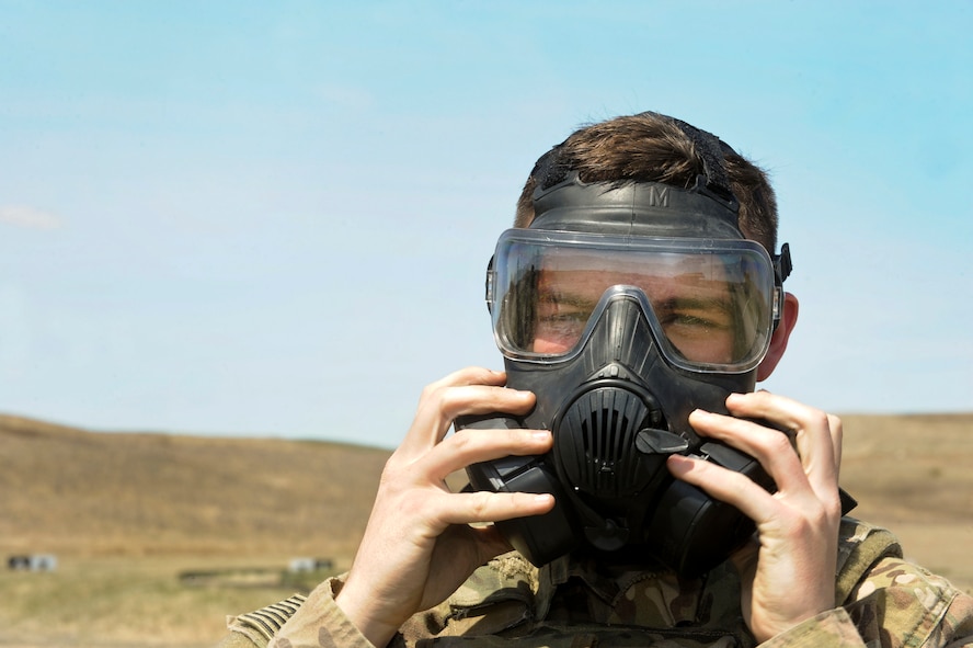 Airman Ryan Benjamin, 91st Missile Security Forces Squadron response force member, puts on a gas mask at Camp Grafton South, Devil’s Lake, N.D., May 4, 2017. The 91st Security Forces Group Global Strike Challenge team trained in preparation for the upcoming competition, which challenges security forces tactics, job knowledge and weapons firing. (U.S. Air Force photo/Airman 1st Class Jessica Weissman)