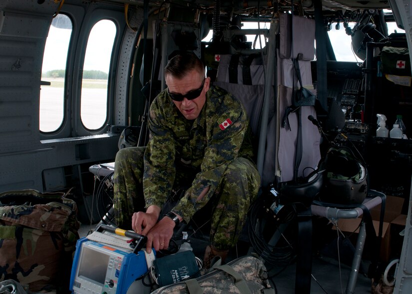 Canadian Cpl. Jason Flegel, a forward aeromedevac specialist with the 2nd Field Ambulance, readies medical equipment and his personal gear aboard a Blackhawk helicopter prior to performing a joint Medevac training mission with members of the 1-169th Aviation Regiment during Exercise Maple Resolve 17 at Camp Wainwright, Alberta, on May 16, 2017. Exercise Maple Resolve is an annual collective training event designed for any contingency operation. Approximately 4,000 Canadian and 1,000 U.S. troops are participating in Exercise Maple Resolve 17.