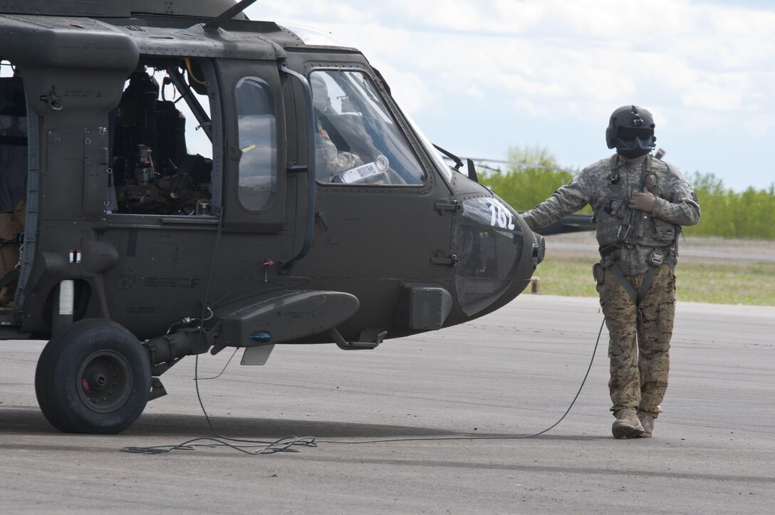 Sgt. Christopher Raynor, a crew chief with the 1-169th Aviation Regiment, prepares to embark on a joint medevac training mission during Exercise Maple Resolve 17 at Camp Wainwright, Alberta, May 16, 2017. Exercise Maple Resolve is an annual collective training event designed for any  contigency operation. Approximately 4,000 Canadian and 1,000 U.S. troops are participating in Exercise Maple Resolve 17.