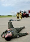 Capt. Matt McKay, a pilot trainee with the 757th Airlift Squadron here, portrays an accident victim during a Major Accident Response Exercise (MARE), May 16, 2017, while installation firefighters arrive and coordinate their initial response. The purpose of the exercise, conducted by the Wing Inspection Team and Emergency Management office, was to document response capabilities of installation personnel while honing joint response practices with local agencies including local law enforcement and the American Red Cross. (U.S. Air Force photo/Eric White)