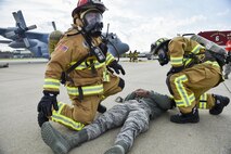 Kevin Brichetto and Staff Sgt. Scott Carey, both firefighters with the 910th Civil Engineer Fire Department here, treat a simulated victim during a Major Accident Response Exercise (MARE), May 16, 2017. The purpose of the exercise, conducted by the Wing Inspection Team and Emergency Management office, was to document response capabilities of installation personnel while honing joint response practices with local agencies including local law enforcement and the American Red Cross. (U.S. Air Force photo/Eric White)