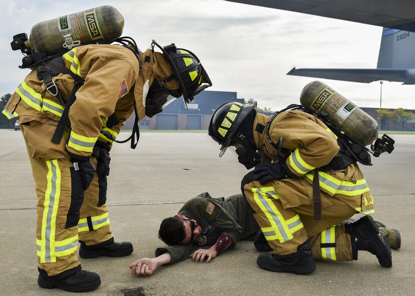 Jarrod Busby and Senior Airman Andrew Javornick, both firefighters with the 910th Civil Engineer Fire Department, inspect injuries on Second Lt. John Pope, a pilot trainee with the 757th Airlift Squadron, who is portraying an accident victim during a Major Accident Response Exercise (MARE), May 16, 2017. Exercise organizers use moulage, cosmetics intended to simulate injuries, to enhance the realism of the scenario. The purpose of the exercise, conducted by the Wing Inspection Team and Emergency Management office, was to document response capabilities of installation personnel while honing joint response practices with local agencies including local law enforcement and the American Red Cross. (U.S. Air Force photo/Eric White)