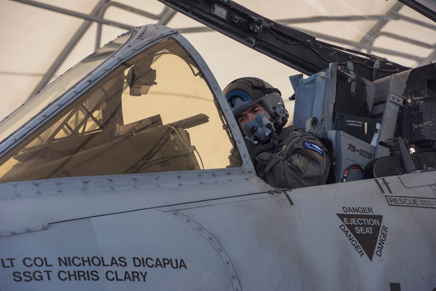 Col. Mark Barrera, 23d Wing vice commander, secures his flight helmet prior to performing his fini flight from Moody Air Force Base, Ga., May 15, 2017. Upon completion of their final flights, military aviators are hosed down with water by their comrades, family, and friends before they depart their squadron. Barrera will continue his Air Force career by attending the Joint Military Attaché School to become an Air Attaché in Italy. During this tenure, he will act as an embassy liaison with host-nation defense establishments, openly observe and report developments and significant events, and actively participate in national security and operational policy development and coordination. (U.S. Air Force photo by Senior Airman Greg Nash)