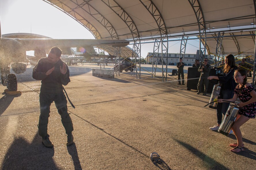 Children greet their father, Col. Mark Barrera, 23d Wing vice commander, with hoses after his completion of a fini flight from Moody Air Force Base, Ga., May 15, 2017. Upon completion of their final flights, military aviators are hosed down with water by their comrades, family, and friends before they depart their squadron. Barrera will continue his Air Force career by attending the Joint Military Attaché School to become an Air Attaché in Italy. During this tenure, he will act as an embassy liaison with host-nation defense establishments, openly observe and report developments and significant events, and actively participate in national security and operational policy development and coordination. (U.S. Air Force photo by Senior Airman Greg Nash)