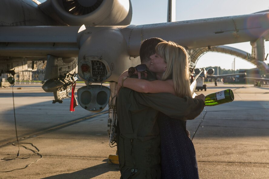 Col. Mark Barrera, 23d Wing vice commander, embraces his wife after completing his fini flight from Moody Air Force Base, Ga., May 15, 2017. Upon completion of their final flights, military aviators are hosed down with water by their comrades, family, and friends before they depart their squadron. Barrera will continue his Air Force career by attending the Joint Military Attaché School to become an Air Attaché in Italy. During this tenure, he will act as an embassy liaison with host-nation defense establishments, openly observe and report developments and significant events, and actively participate in national security and operational policy development and coordination. Upon completion of their final flights, military aviators are hosed down with water by their comrades, family, and friends before they depart their squadron. Barrera will continue his Air Force career by attending Italy’s Joint Military Attaché School to become an Air Attaché. During this tenure, he will act as an embassy liaison with host-nation defense establishments, openly observe and report developments and significant events, and actively participate in national security and operational policy development and coordination. (U.S. Air Force photo by Senior Airman Greg Nash)