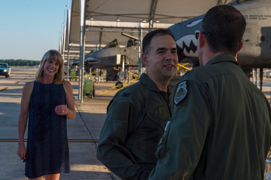 Col. Mark Barrera, 23d Wing vice commander, embraces Lt. Col. Sean Hall, 75th Fighter Squadron commander, after completing his fini flight from Moody Air Force Base, Ga., May 15, 2017. Upon completion of their final flights, military aviators are hosed down with water by their comrades, family, and friends before they depart their squadron. Barrera will continue his Air Force career by attending the Joint Military Attaché School to become an Air Attaché in Italy. During this tenure, he will act as an embassy liaison with host-nation defense establishments, openly observe and report developments and significant events, and actively participate in national security and operational policy development and coordination. (U.S. Air Force photo by Senior Airman Greg Nash)