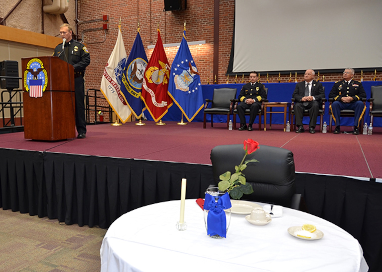 Defense Logistics Agency Installation Support at Richmond Police Officer Sgt. Bradley McCoy highlights the Table of Honor representing officers who died in the line of duty and explained its significance to those gathered for a ceremony honoring fallen law enforcement officers May 11, 2017 in the Frank B. Lotts Conference Center on Defense Supply Center Richmond, Virginia. 