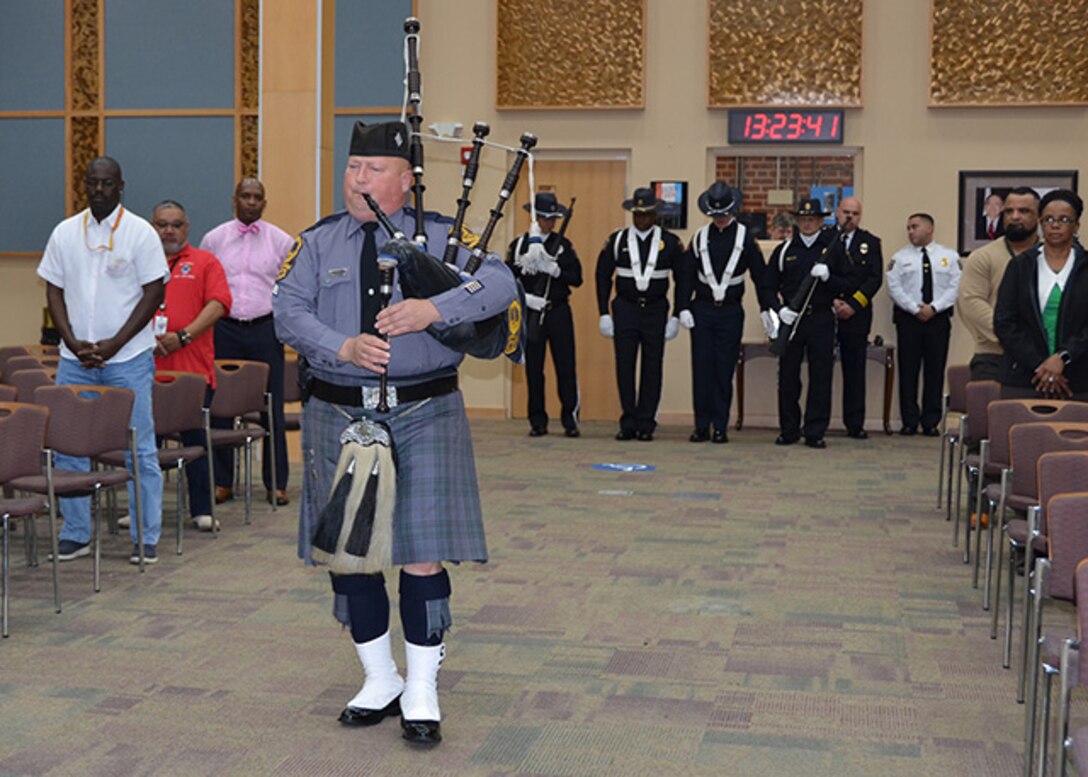 Virginia State Police Trooper Sgt. Mike McCann performs “Amazing Grace” on bagpipes during a ceremony May 11, 2017 honoring fallen law enforcement officers in the Frank B. Lotts Conference Center on Defense Supply Center Richmond, Virginia. 