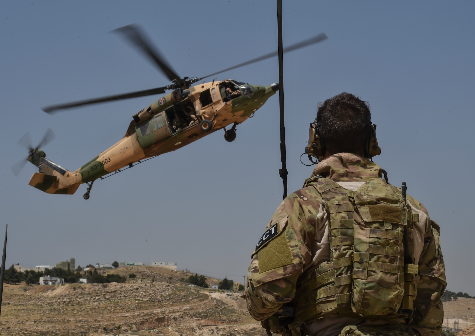 A U.S. Air Force Special Tactics Airman controls the approach of a Royal Jordanian Air Force UH-60L Blackhawk helicopter during Exercise Eager Lion for a personnel recovery training mission May 11, 2017, at King Abdullah II Special Operations Training Center. (U.S. Air Force photo/Senior Airman Ryan Conroy)