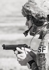 Tech. Sgt. Kyle Douglas, 91 Security Forces Group NCO in charge of physical security, prepares to fire an M9 pistol at Camp Grafton, N.D., May 4, 2017. The Global Strike Challenge team fired the M9 and M4 in a variety of positions and situations to prepare for the competition. (U.S. Air Force photo/Senior Airman J.T. Armstrong)