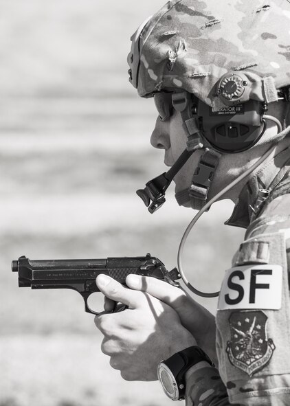 Tech. Sgt. Kyle Douglas, 91 Security Forces Group NCO in charge of physical security, prepares to fire an M9 pistol at Camp Grafton, N.D., May 4, 2017. The Global Strike Challenge team fired the M9 and M4 in a variety of positions and situations to prepare for the competition. (U.S. Air Force photo/Senior Airman J.T. Armstrong)