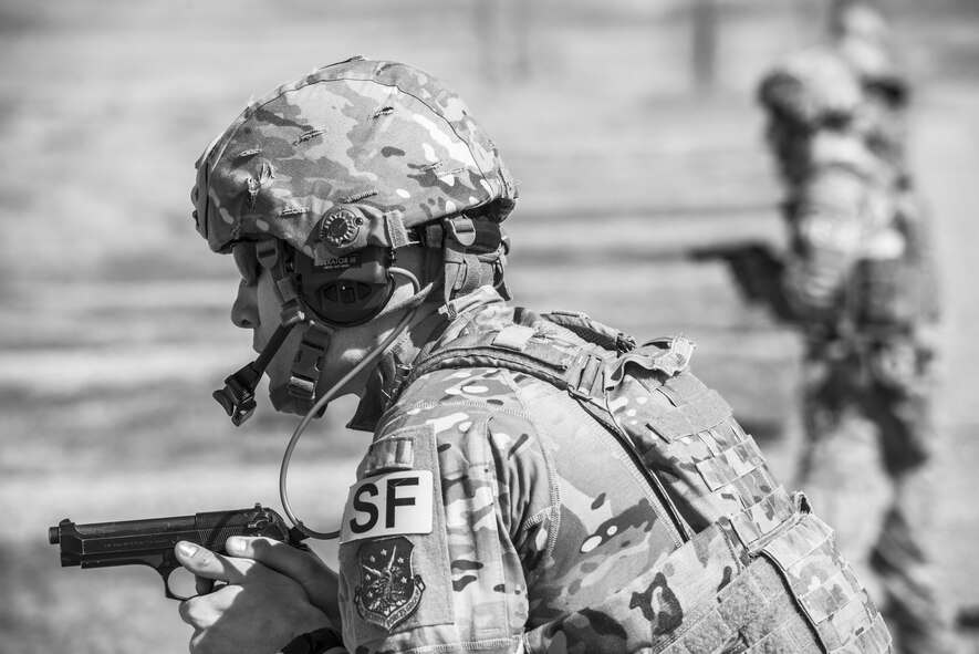 Tech. Sgt. Kyle Douglas, 91 Security Forces Group NCO in charge of physical security, prepares to fire an M9 pistol at Camp Grafton, N.D., May 4, 2017. The Global Strike Challenge team fired the M9 and M4 in a variety of positions and situations to prepare for the competition. (U.S. Air Force photo/Senior Airman J.T. Armstrong)