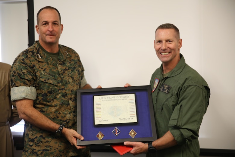 Maj. Gen. Daniel O’Donohue, left, 1st Marine Division commanding general, awards Col. Michael Borgschulte, right, commanding officer of Marine Aircraft Group (MAG) 39, a certificate of honorary membership at Marine Corps Air Station Camp Pendleton, Calif., May 15. 1st MARDIV recognized MAG-39 as an honorary member for continuing to support I MEF ground Marines and continuously working toward more advanced Marine air-ground task force integration. (U.S. Marine Corps photo by Lance Cpl. Jake M.T. McClung/Released)