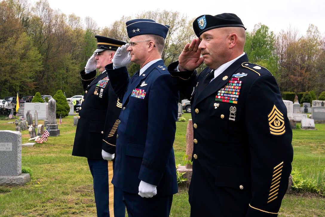 Vermont Army National Guard Master Sgt. Daniel Landry, left, Air Force Maj. Gen. Steven Cray, center, adjutant general of the Vermont National Guard, and Vermont Army National Guard Command Sgt. Maj. Joseph Quick render honors as the remains of Army Cpl. George A. Perreault are escorted to his gravesite at Saint Francis Xavier Cemetery, Winooski, Vt., May 13, 2017. Perreault, who was reported missing in action on February 13, 1951, during the Korean War, was recently identified and returned to his family for burial with full military honors. Air National Guard photo by Tech. Sgt. Sarah Mattison