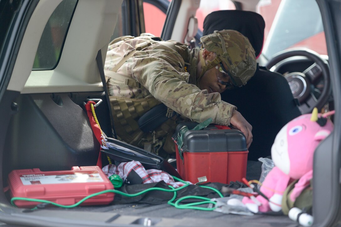 Sgt. 1st Class Steven Vaughn, U.S. Army Human Resources Command professional development NCO, performs a vehicle search during the situational training exercise at the Command’s Best Warrior Competition held on Fort Knox, Ky., May 8-11, 2017. The top Noncommissioned Officer and Junior Enlisted Soldier of this competition will each move on to the Fort Knox Installation competition held on post 21-25 May.  (U.S. Army Photo by Charlie Leffler)
