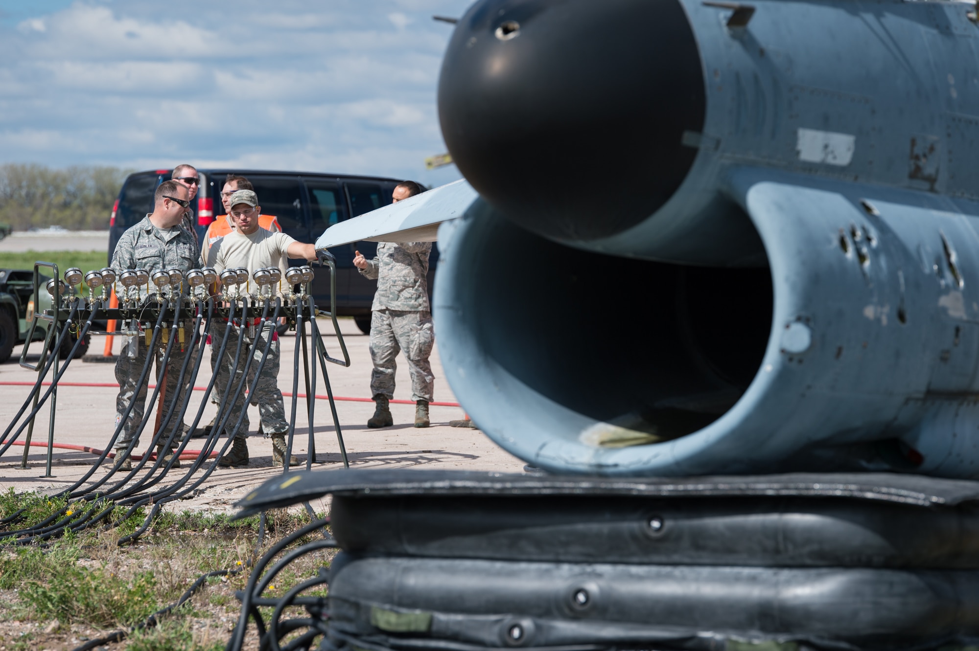 U.S. Air Force Airmen with the 153rd Maintenance Group's Crash Damage or Disabled Aircraft Recovery team monitor an air manifold during jacking of an A-7 Corsair II aircraft, May 11, 2017 in Cheyenne, Wyoming. Maintainers from all aircraft specialties practiced moving a fighter aircraft from the mud into a parking spot as part of an annual CDDAR requirement. (U.S. Air National Guard photo by Senior Master Sgt. Charles Delano/released)