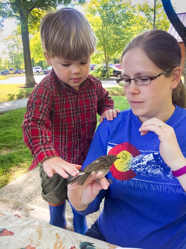 Caesar Creek Lake volunteer, and former park ranger, Rebecca Palmer puts on a bird banding demonstration at the Visitor Center in support of International Migratory Bird Day at Caesar Creek Lake, Waynesville, Ohio.  Rebecca utilized the bird banding demonstration to teach this inquisitive youngster about local bird species.  Throughout the year the Caesar Creek Lake Visitor Center has numerous public bird banding demonstrations.
