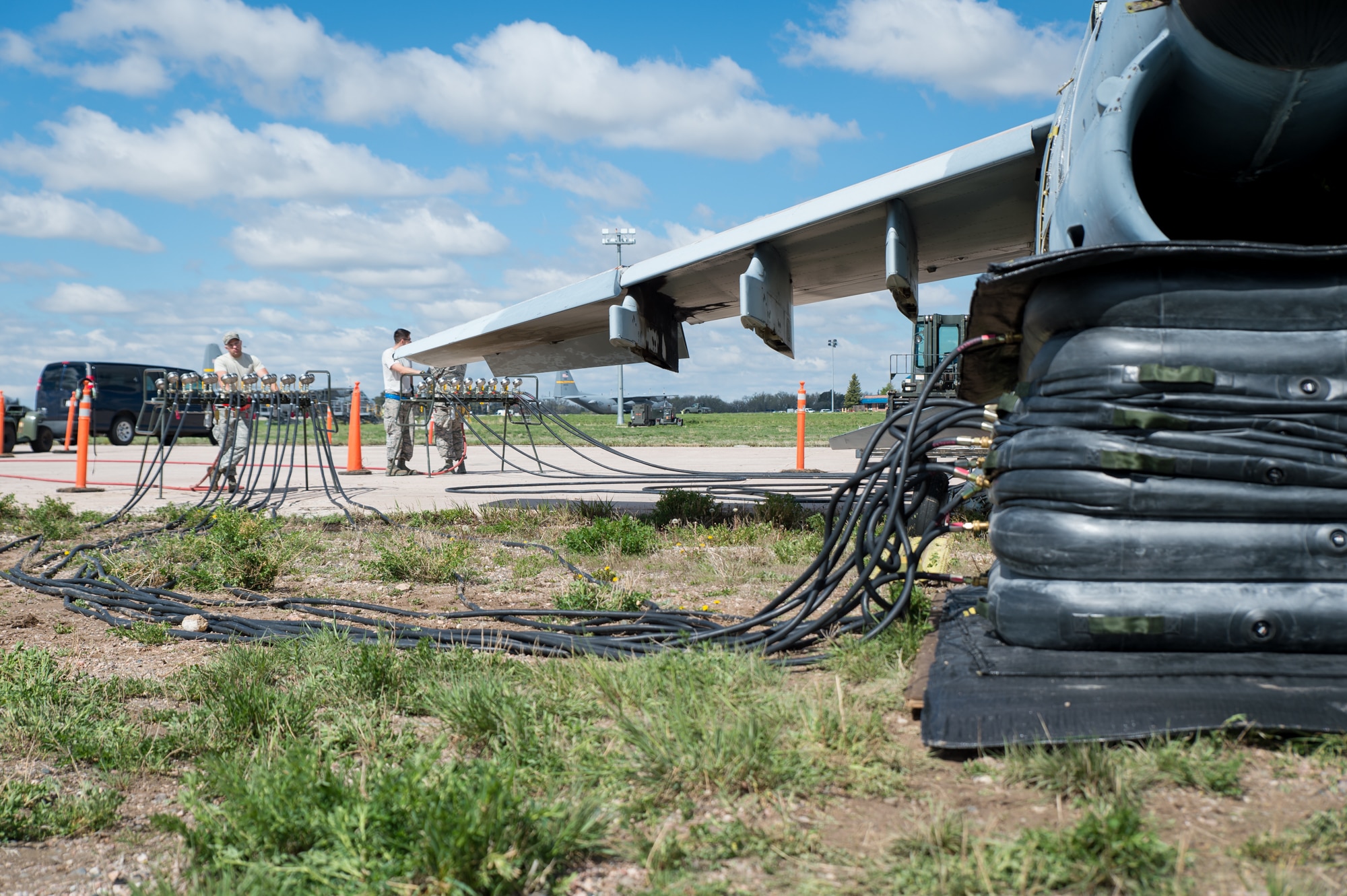 U.S. Air Force Senior Airman Dakota Difrancesco with the 153rd Maintenance Group's Crash Damage or Disabled Aircraft Recovery team monitors a manifold during the jacking of an A-7 Corsair II aircraft, May 11, 2017 in Cheyenne, Wyoming. Maintainers from all aircraft specialties practiced moving a fighter aircraft from the mud into a parking spot as part of an annual CDDAR requirement. (U.S. Air National Guard photo by Senior Master Sgt. Charles Delano/released)