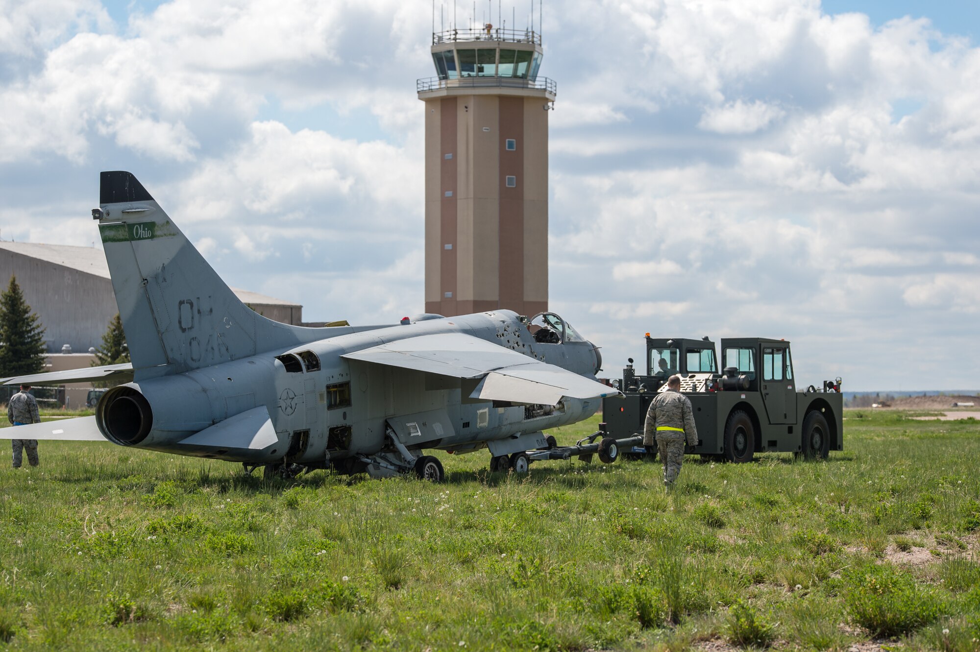 U.S. Air Force Airmen with the 153rd Maintenance Group's Crash Damage or Disabled Aircraft Recovery tow an A-7 Corsair II aircraft, May 11, 2017 in Cheyenne, Wyoming. Maintainers from all aircraft specialties practiced moving a fighter aircraft from the mud into a parking spot as part of an annual CDDAR requirement. (U.S. Air National Guard photo by Senior Master Sgt. Charles Delano/released)