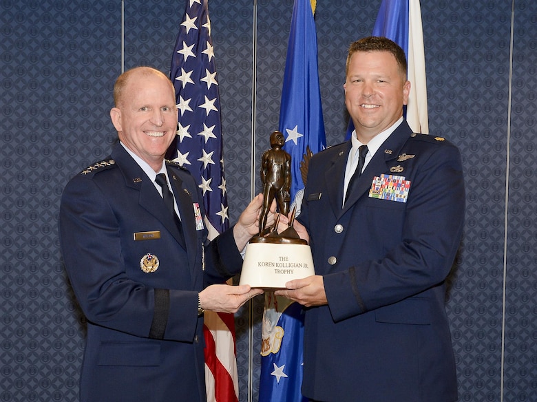 Air Force Vice Chief of Staff Gen. Stephen Wilson presents the Koren Kolligian Trophy to Maj. John Hourigan, a 123rd Operations Support Squadron C-130 Hercules pilot, during a ceremony in the Pentagon, Washington, D.C., May 17, 2017. (U.S. Air Force Photo/Andy Morataya)