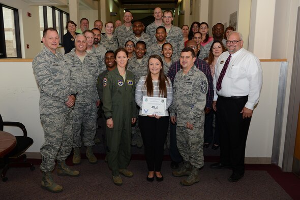 Stormi Addison, 47th Force Support Squadron student assignment counselor (center), accepts the “XLer of the Week” award from Col. Michelle Pryor, 47th Flying Training Wing vice commander (left), and Chief Master Sgt. George Richey, 47th FTW command chief (right), on Laughlin Air Force Base, Texas, May 10, 2017. The XLer is a weekly award chosen by wing leadership and is presented to those who consistently make outstanding contributions to their unit and Laughlin. (U.S. Air Force photo/Airman 1st Class Benjamin N. Valmoja)