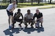 Competitors representing the 822d Base Defense Squadron pose for a photo after winning sprints to the finish line becoming the first to finish the ruck march portion of the Police Week Quadathalon, May 15, 2017, at Moody Air Force Base, Ga. Teams of four participated in a swim, run, bike and ruck march competition, where the team with the fastest time won bragging rights. Overall, Police Week is designed to honor the legacies fallen officers, both civilian and military, have left behind, but it also gives various sections within the law enforcement community an opportunity to train together in friendly competitions. (U.S. Air Force photo by Senior Airman Janiqua P. Robinson)