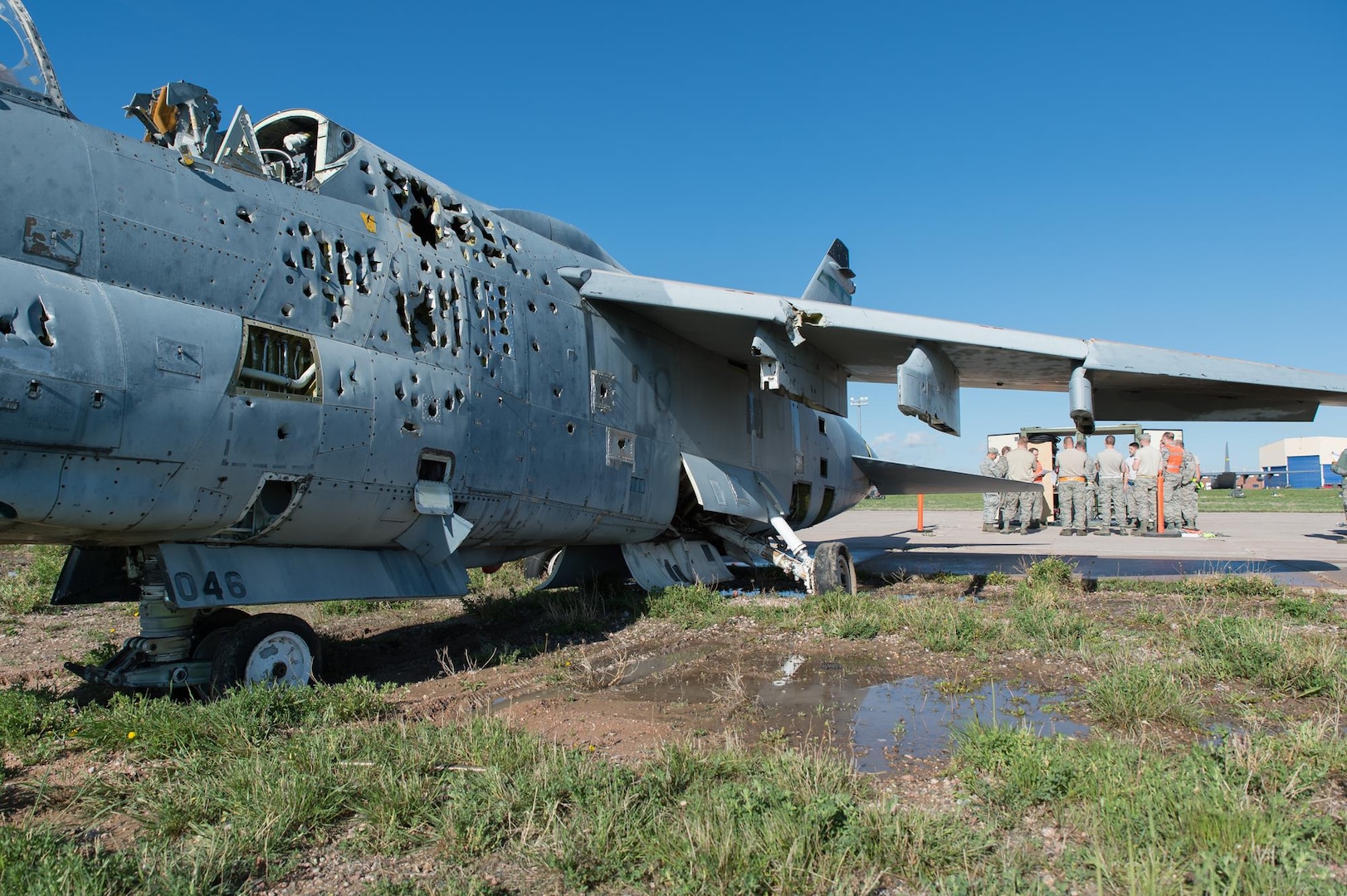U.S. Air Force Airmen with the 153rd Maintenance Group's Crash Damage or Disabled Aircraft Recovery team conduct a safety briefing prior to jacking an A-7 Corsair II aircraft, May 11, 2017 in Cheyenne, Wyoming. Maintainers from all aircraft specialties practiced moving a fighter aircraft from the mud into a parking spot as part of an annual CDDAR requirement. (U.S. Air National Guard photo by Senior Master Sgt. Charles Delano/released)