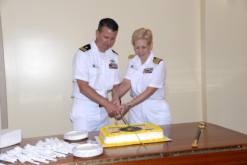 Navy nurses Lt. Terry Starkey, an occupational medicine officer at Naval Health Clinic Charleston, and Capt. Kathleen Hinz, NHCC executive officer, cut the cake during NHCC's ceremony celebrating National Nurses Week May 12 at NHCC. 