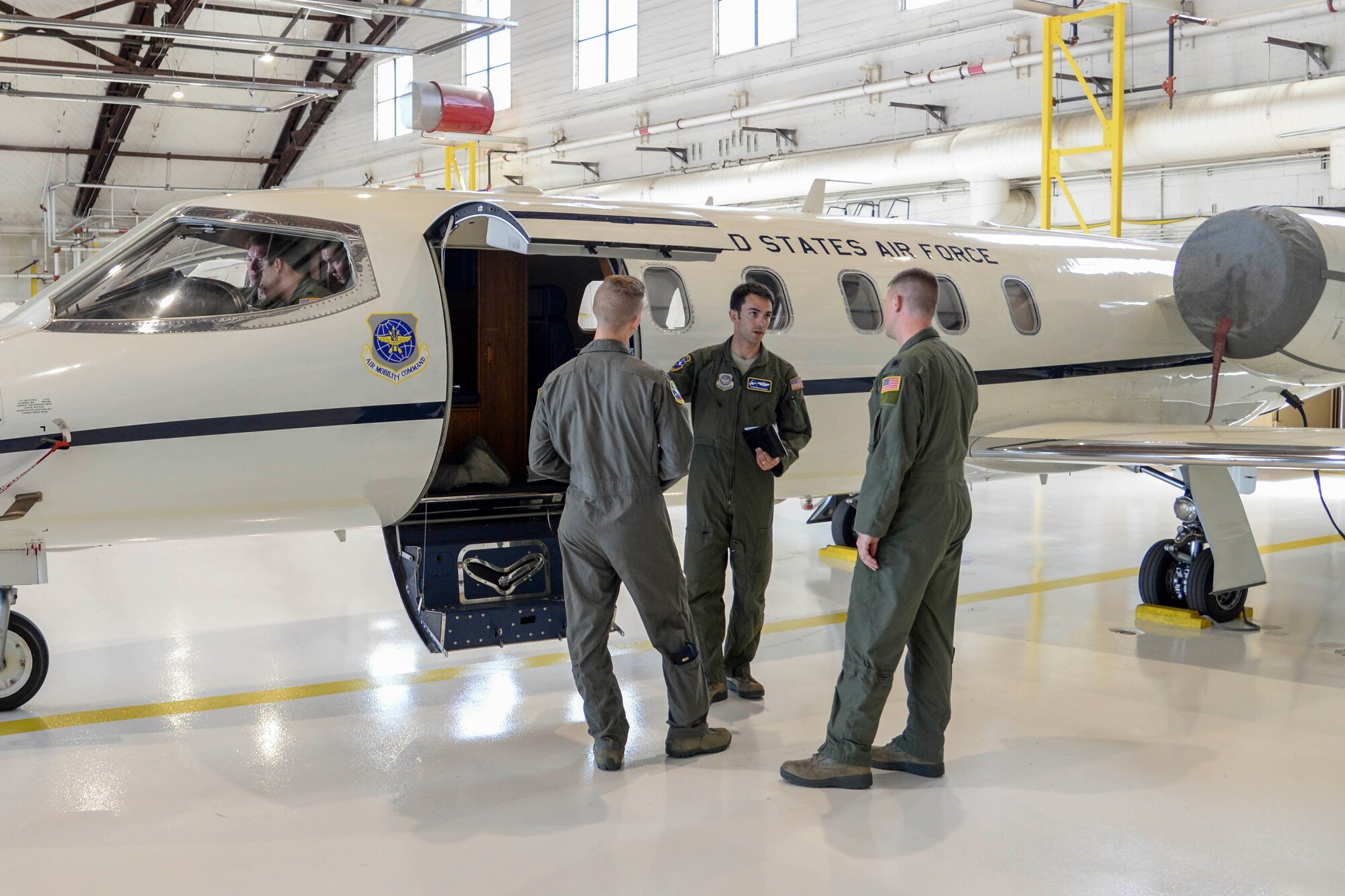 Maj. Stephen Raham, 458th Airlift Squadron Formal Training Unit chief, speaks with students of the C-21A FTU course inside of the 458th AS building at Scott AFB, IL, May 15.  The 458th AS FTU manages five training courses and graduates approximately 60 students or 19 classes per fiscal year. (U.S. Air Force photo by Airman Chad Gorecki)