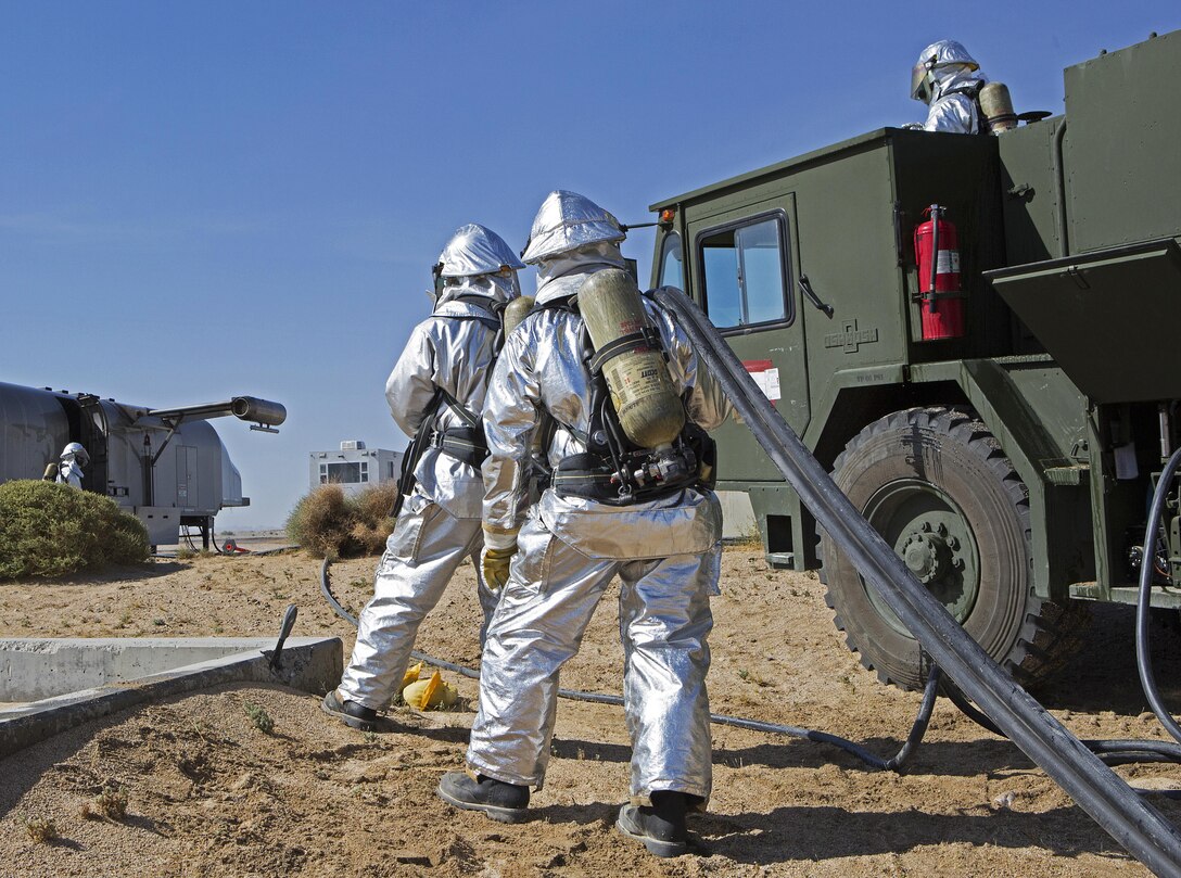 MARINE CORPS AIR GROUND COMBAT CENTER TWENTYNINE PALMS, Calif. –Expeditionary fire and rescue (EFR) Marines with Marine Wing Support Squadron (MWSS) 373 prepare to extinguish a fire during a simulated emergency exercise for Integrated Training Exercise (ITX) 3-17 on Marine Corps Air Ground Combat Center Twentynine Palms, Calif., May 10. ITX is a combined-arms exercise enabling Marines across 3rd Marine Aircraft Wing to operate as an aviation combat element integrated with ground and logistics combat elements as a Marine air-ground task force.  Approximately 650 Marines and 27 aircraft with 3rd MAW supported ITX 3-17. (U.S. Marine Corps photo by Lance Cpl. Becky L. Calhoun/Released)