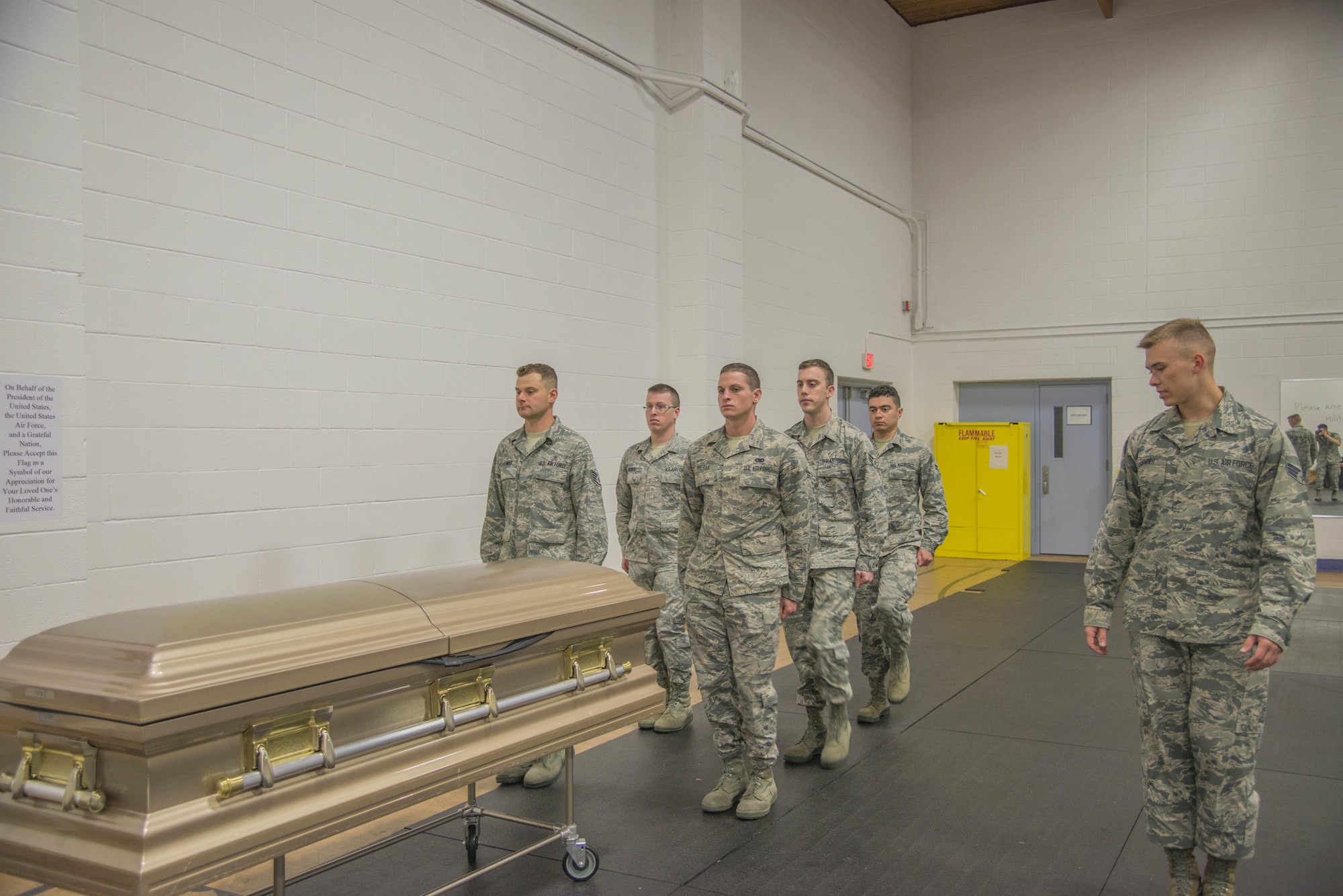 Senior Airman Andrew Zander, Air Force Honor Guard, observes as trainees practice the casket retrieval procedures during training at the Scott Air Force Base Honor Guard, May 9, 2017. The Air Force Honor Guard conducts training at multiple bases a year to make sure the standard is maintained Air Force wide. (U.S. Air Force photo by Airman 1st Class Daniel Garcia)