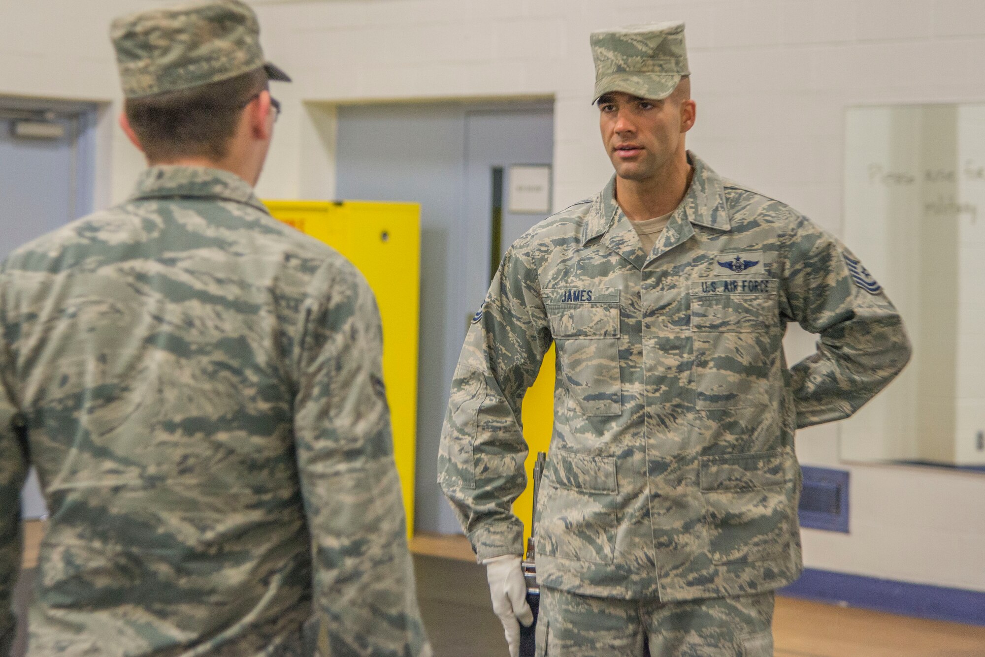 Tech. Sgt. Matthew James, Air Force Honor Guard, demonstrates basic Colors standing manuals for Airman 1st Class Tyler Harbin, 375th Communication Support Squadron, with the Scott Air Force Base Honor Guard,  May 9, 2017. The Air Force Honor Guard conducts training at multiple bases a year to make sure the standard is maintained Air Force wide. (U.S. Air Force photo by Airman 1st Class Daniel Garcia)