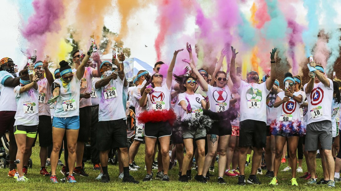 Participants in the Marine Corps Community Services Semper Fit Color Fun Run 5K shoot color cannons into the air to start the run at Marine Corps Air Station Cherry Point, N.C., May 13, 2017. More than 200 people participated in the event. Marine Corps photo by Lance Cpl. Cody Lemons