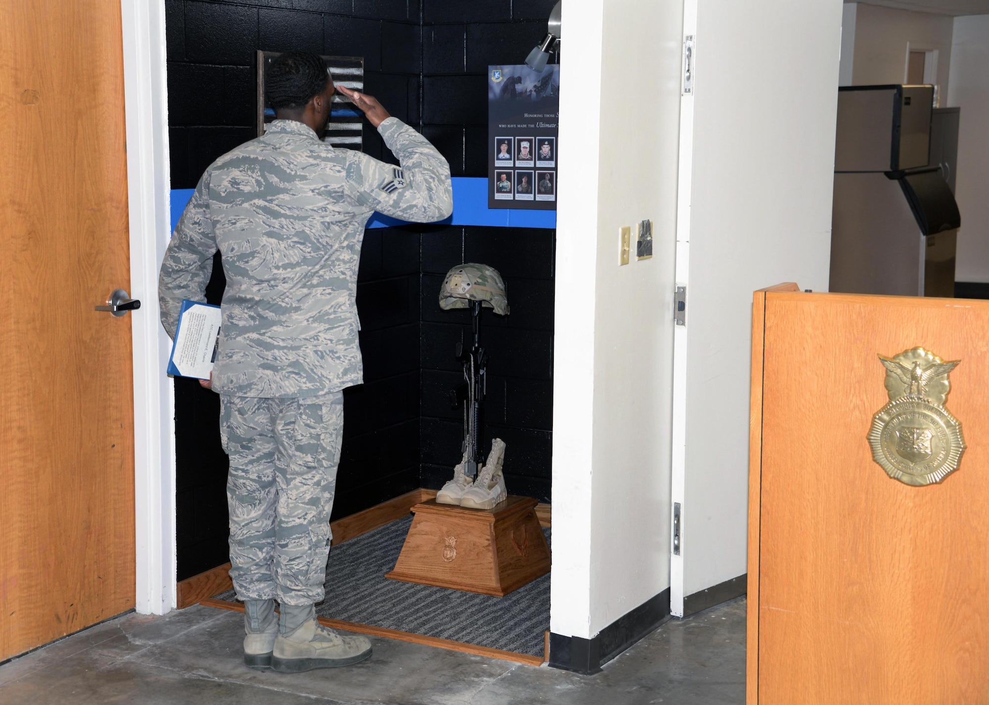 The 82nd Security Forces Squadron held a ceremony at Sheppard Air Force Base, Texas, May 17, 2017, which honored defenders who have made the ultimate sacrifice serving their country. Senior Airman Earnest Jackson Jr., 82nd SFS combat arms instructor, salutes the battlefield cross, which holds the dog tags of fallen defenders. (U.S. Air Force photo by Senior Airman Robert L. McIlrath)