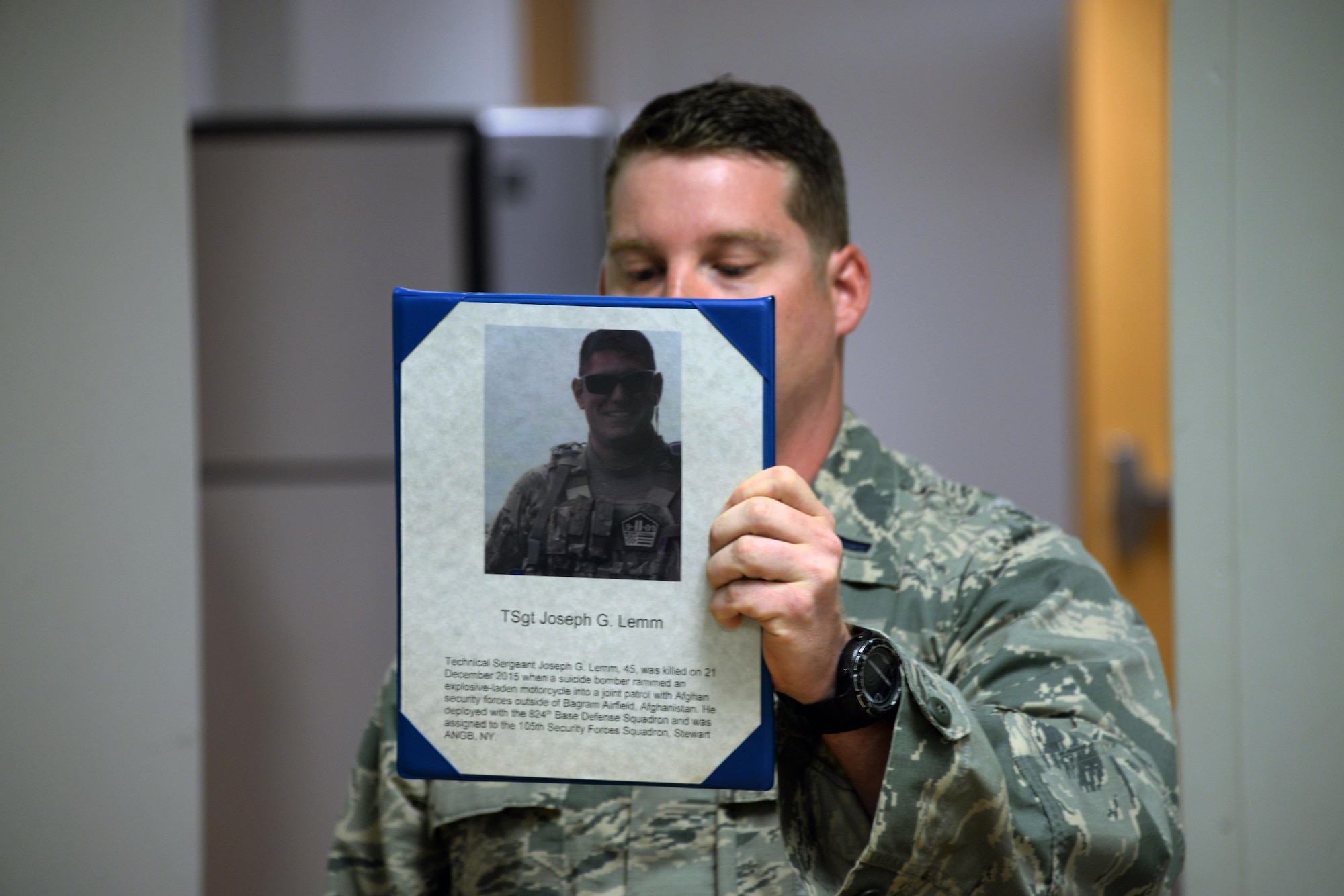 The 82nd Security Forces Squadron held a ceremony at Sheppard Air Force Base, Texas, May 17, 2017, which honored defenders who have made the ultimate sacrifice serving their country. 1st Lt. Bryan Duggan, 82nd SFS operations officer, holds up a picture of Tech. Sgt. Joseph Lemm, a fellow defender who was killed on Dec. 21, 2015, by a suicide bomber. Lemm was assigned to the 105th SFS at Stewart Air National Guard Base, New York. (U.S. Air Force photo by Senior Airman Robert L. McIlrath)