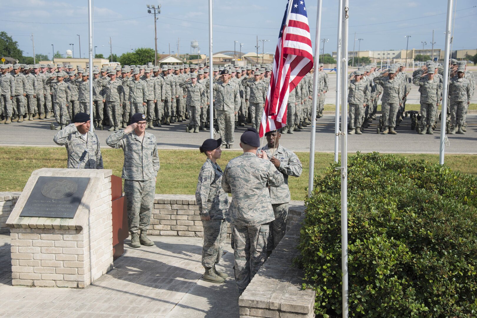 Members of the 343rd Training Squadron lower the flag at the Joint Base San Antonio Police Week retreat ceremony held in honor of fallen officers May 15, 2017, outside the Security Forces Museum at JBSA-Lackland. JBSA security forces members and military police officers joined local police departments to honor their comrades who were killed in action. (U.S. Air Force photo by Airman Dillon Parker)