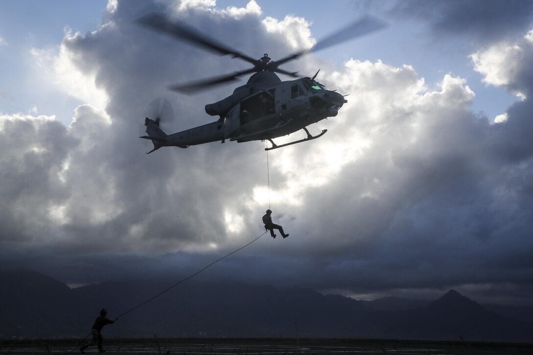 A U.S. Marine Corps UH-1Y Huey assigned to Marine Light Attack Helicopter Squadron 367 hovers over the ground at Landing Zone Westfield during a fast rope exercise aboard Marine Corps Air Station Kaneohe Bay on May 10, 2017. The mission of HMLA-367 is to support the Marine Air-Ground Task Force commander by providing offensive air support, armed escort and airborne supporting arms coordination, day or night, under all weather conditions during expeditionary, joint, or combined operations. (U.S. Marine Corps photo by Gunnery Sgt Ezekiel R. Kitandwe)