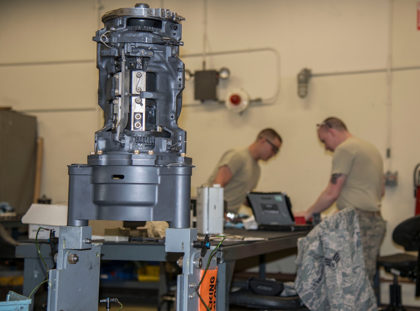A M61A1 20mm Gatling Gun sits on a stand while U.S. Air Force Senior Airman Joshua Wood and Airman 1st Class John Williams, both 35th Maintenance Squadron armament technicians, work on breach bolts at Kunsan Air Base, Republic of Korea, May 15, 2017. Breach bolts pulls the round into the rotor, pulling it forward so it can fire then pulls it back. This was a part of an 18-month inspection where they completely break down the M61A1 20mm Gatling Gun and rebuild it, repairing or replacing any components that have been damaged. 