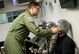 Senior Airman Christopher Connolly, 779th Aerospace Medical Squadron physiologist, assists David Kinsella with sealing his oxygen mask inside an altitude simulator chamber March 16, 2017, at Joint Base Andrews, Md. As an inside observer, Connolly was nearby to assist if Kinsella or the other students had physiological complications while experiencing varying levels of air pressure. (U.S. Air Force photo by Staff Sgt. Joe Yanik)