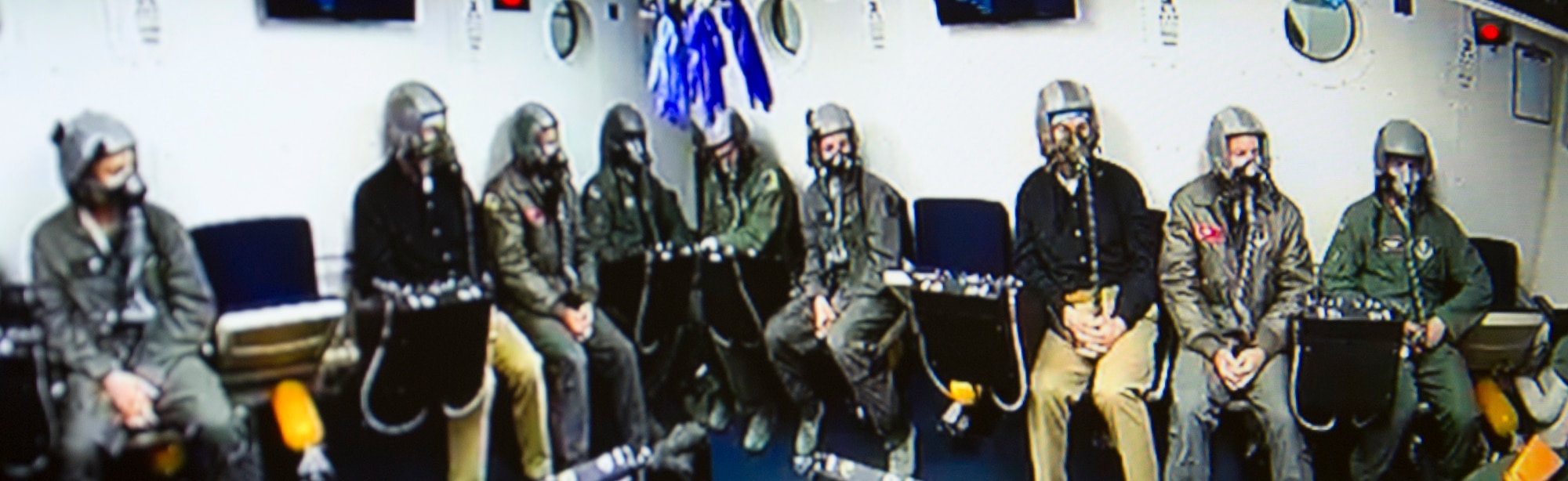 Civilian and military students await the beginning of their altitude training course while inside an enclosed chamber March 16, 2017, at Joint Base Andrews, Md. All were undergoing refresher training, required every five years, to test their ability to identify how their bodies reacted in an environment with varying levels of air pressure. (U.S. Air Force photo by Staff Sgt. Joe Yanik)
