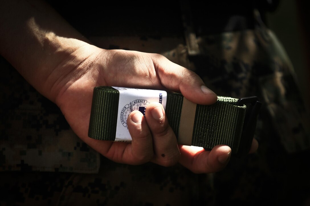 Sgt. Razeem Saheed, a martial arts instructor trainer with the 11th Marine Expeditionary Unit, holds a green Marine Corps Martial Arts Program belt with an instructor's tab behind his back during Martial Arts Instructors Course (MAIC) 1-17 aboard Marine Corps Base Hawaii, May 1, 2017. The MAIC is a three week long course that puts applicants through rigorous training designed to instill teamwork and develop leadership abilities necessary for a Marine Corps Martial Arts Program instructor to teach classes. The Makin Island Amphibious Ready Group/11th MEU is currently underway on their Western Pacific 16-2 deployment. (U.S. Marine Corps photo by Cpl. Aaron S. Patterson/Released)