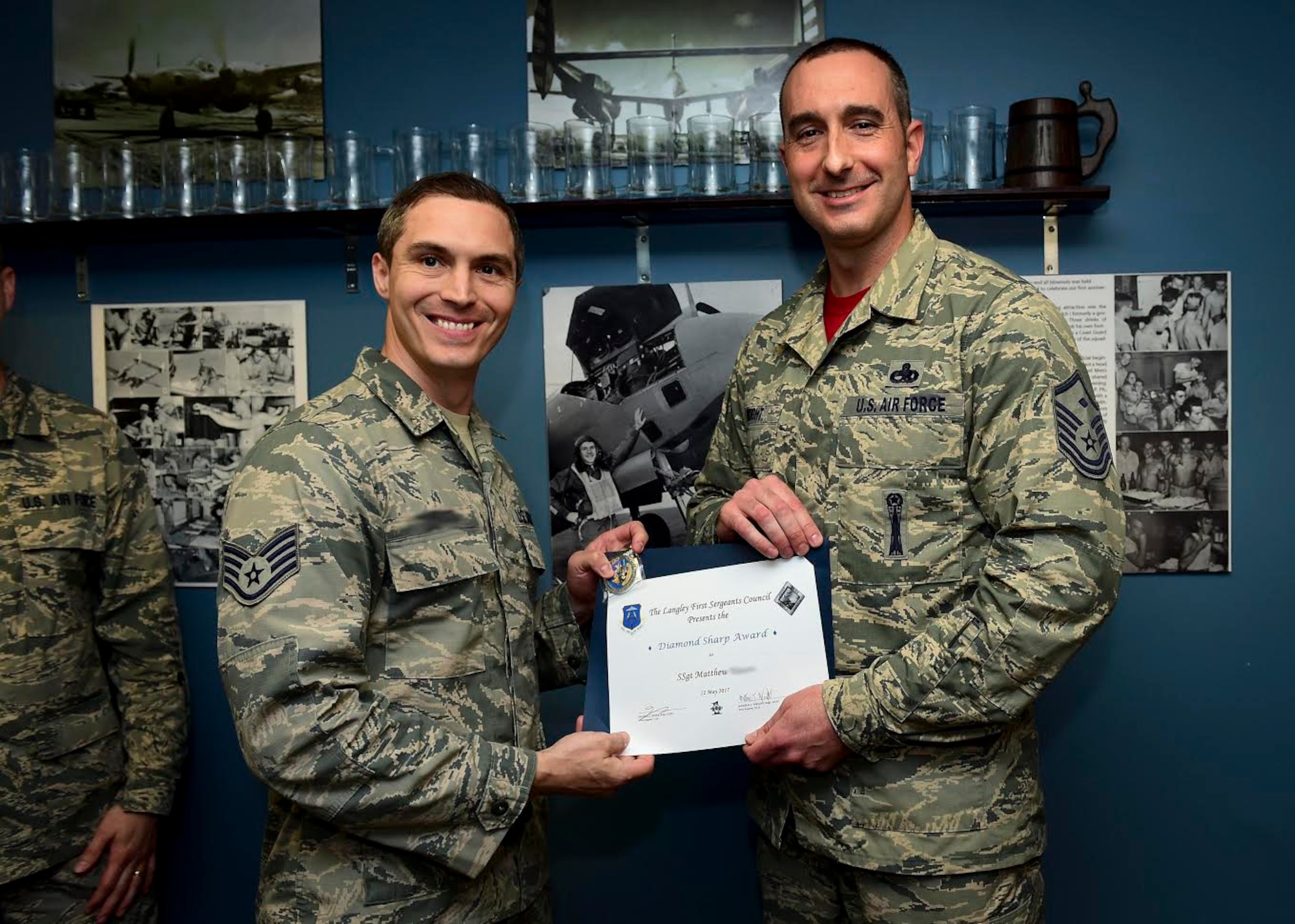 U.S. Air Force Staff Sgt. Matthew, 36th Intelligence Squadron intermediate target development supervisor, accepts the Diamond Sharp Award from Master Sgt. Mathew Wright, 36th IS first sergeant, at Joint Base Langley Eustis, Va., May 12, 2017. The Diamond Sharp Award is presented to Airmen who excel in all areas of their job performance and personal appearance. (U.S. Air Force photo/Staff Sgt. Areca T. Bell) (Photo blurred for security purposes)