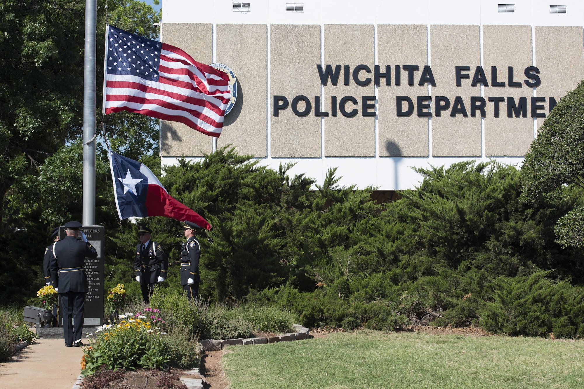 Law enforcement officers from the Wichita Falls, Texas, Police Department, raise the U.S. flag to half-staff during the National Police Week proclamation ceremony, May 15, 2017. National Police Week honors both current and former law enforcement officers as well as officers who’ve paid the ultimate sacrifice. (U.S. Air Force photo by Staff Sgt. Kyle E. Gese)