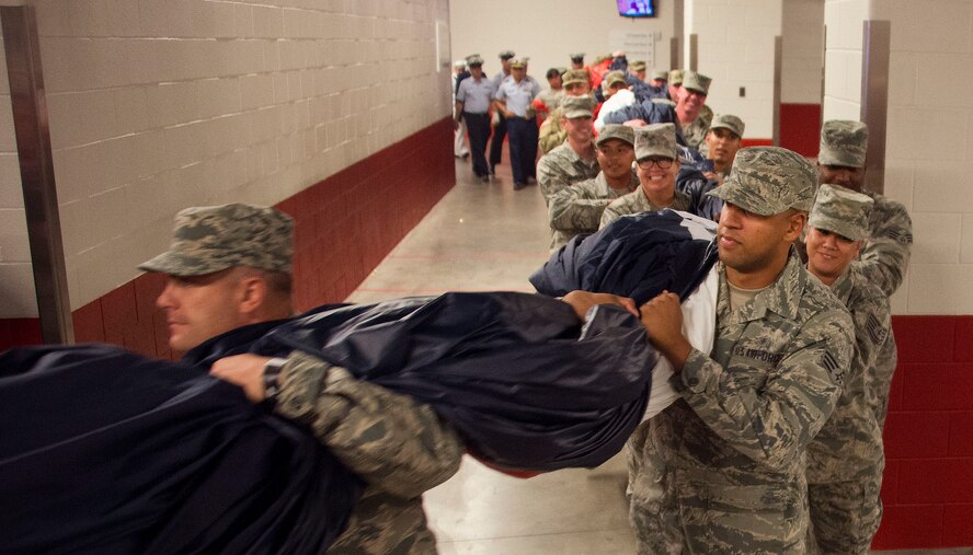 Volunteers from all branches of the military services carry the American Flag at Levis Stadium in Santa Clara, Calif., prior to the playing of the National Anthem at the Monday Night Football season opener featuring the San Francisco 49ers vs. Los Angeles Rams Sept. 12, 2016. The giant flag was large enough to cover the entire playing field. (U.S. Air Force Photo by T.C. Perkins Jr.)
 
