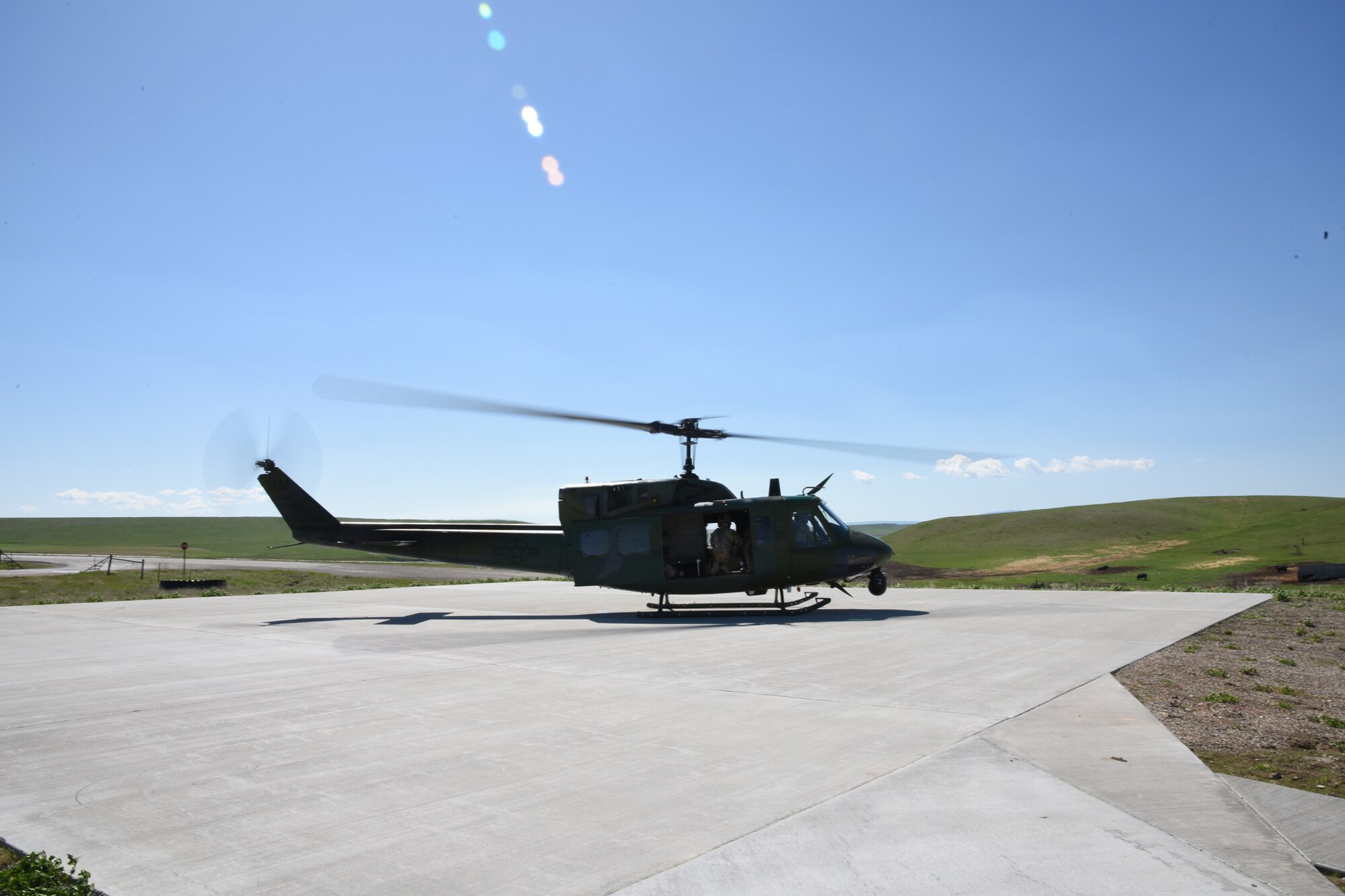 A UH-1N Helicopter from the 40th Helicopter Squadron prepares to take off from a refueling helicopter pad at a missile alert facility May 11, 2017, at Malmstrom Air Force Base, Mont. New helicopter pads and refueling units were recently installed to seven out of 15 MAFs to provide rapid helicopter refueling. (U.S. Air Force photo/ Staff Sgt. Delia Marchick)