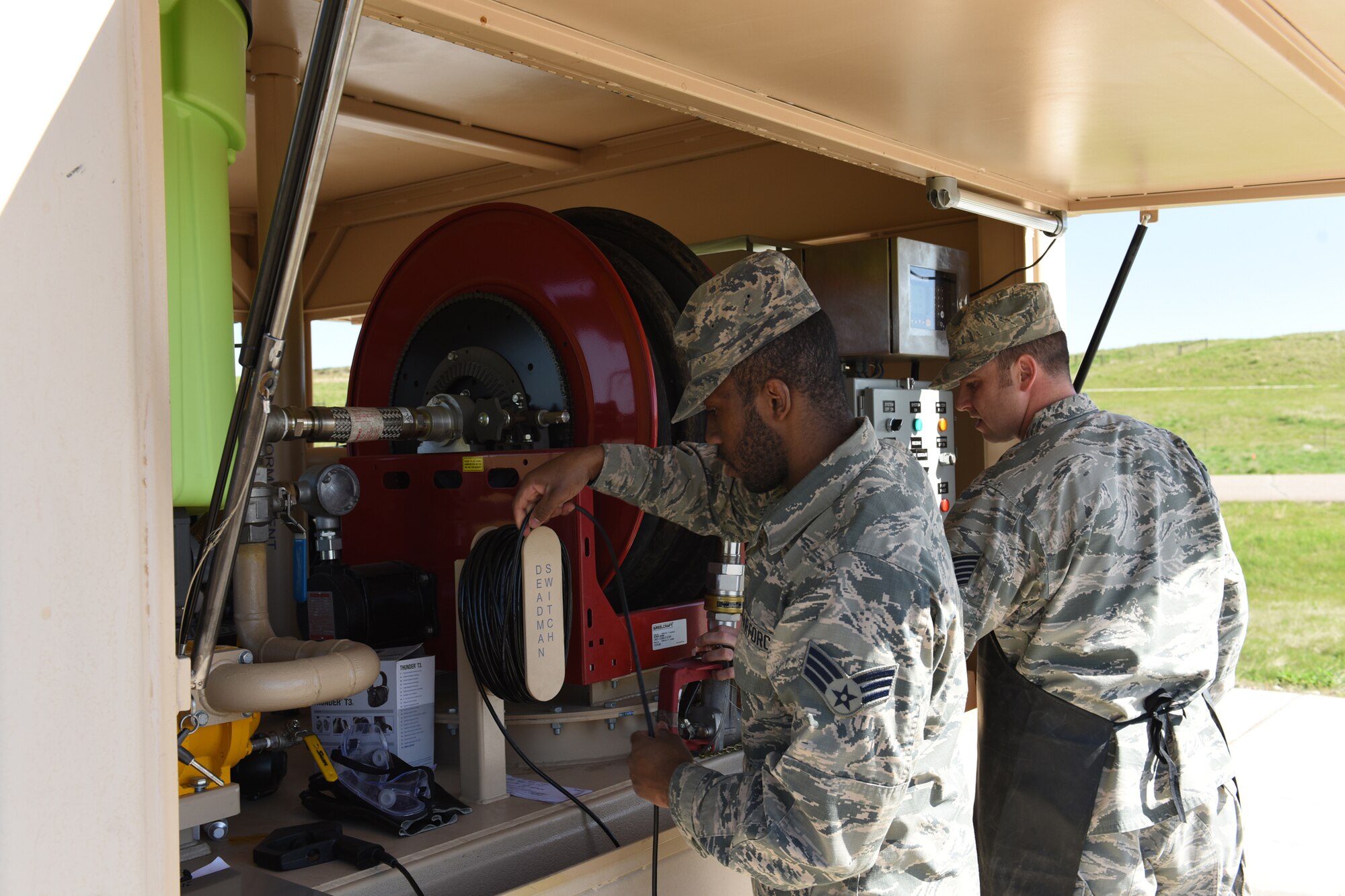 Tech Sgt. Nathan Wiley, 10th Missile Squadron facility manager, right, and Senior Airman Bryan Williams, 341st Force Support Squadron missile chef, run through a pre-operation checklist in preparation for a helicopter refuel at a missile alert facility May 11, 2017, at Malmstrom Air Force Base, Mont. Some of the items on the checklist require a second person, so the facility manager will get assistance from either the missile chef or an available security forces member. (U.S. Air Force photo/ Staff Sgt. Delia Marchick)