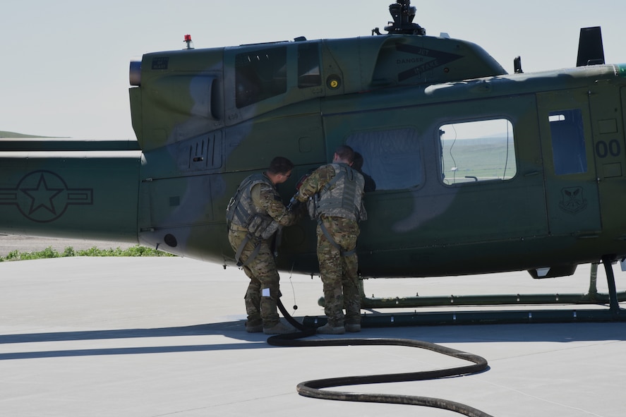 Aircrew from the 40th Helicopter Squadron refuel a UH-1N helicopter at a missile alert facility May 11, 2017, at Malmstrom Air Force Base, Mont. The 40th HS coordinates with the facility manager at MAFs equipped with refueling stations for rapid refuels during missions in the missile field. (U.S. Air Force photo/ Staff Sgt. Delia Marchick)