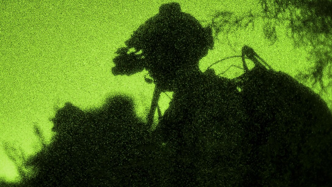 As seen through a night-vision lens, an airman scans his sector member during a training scenario as part of exercise Angel Thunder 17 in Gila Bend, Ariz., May 13, 2017. The airman is assigned to the 58th Rescue Squadron. Air Force photo by Staff Sgt. Sean Martin
